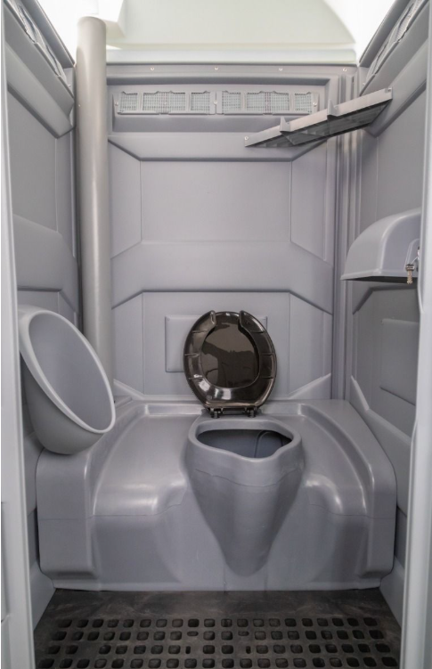 Interior of a PJP4 portable toilet unit with toilet and urinal