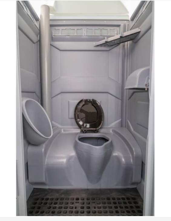 Interior of a PJP4 portable toilet unit with ventilation and shelf