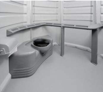Interior of the We'll Care portable toilet unit with toilet and handrails