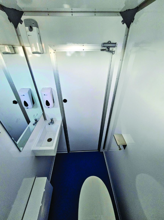 Interior of the ECOLOO restroom unit with sink, mirror and soap dispenser