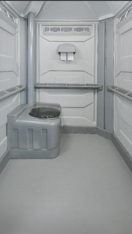 Spacious interior of the Comfort XL portable toilet unit with handrail and toilet paper holder