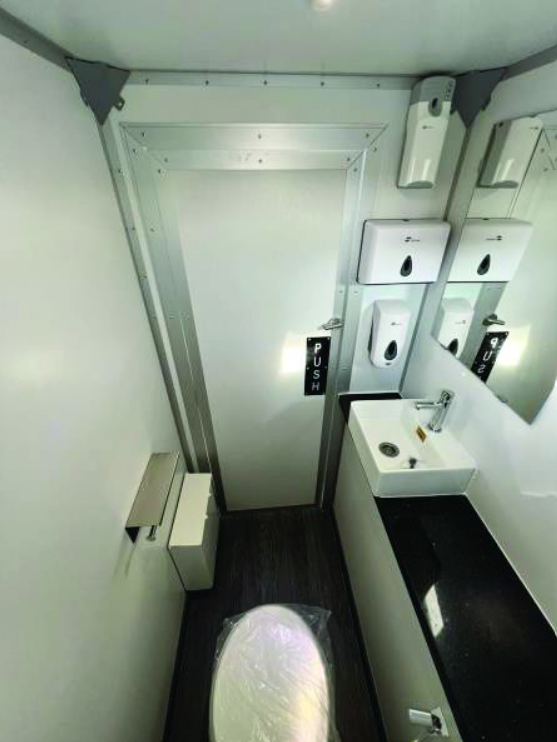 Interior of the ECOLOO restroom unit with sink, mirror and counter space
