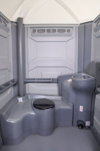 Interior of the Comfort XLT portable toilet unit with toilet, sink and handrail